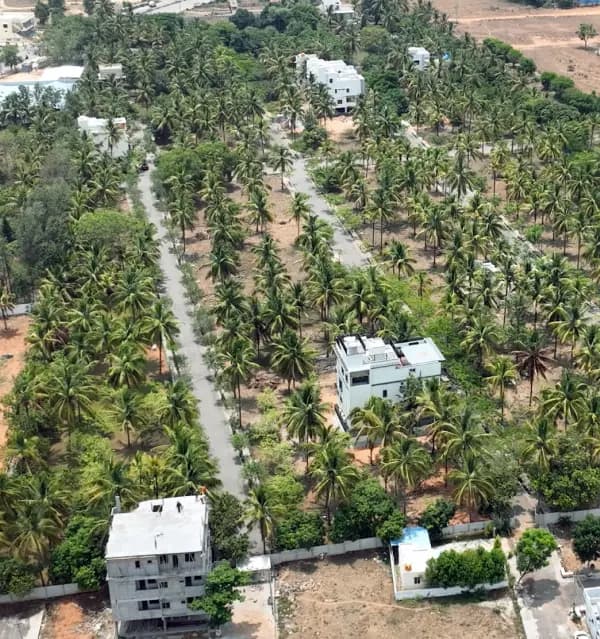 A completed home beside a plot under construction.